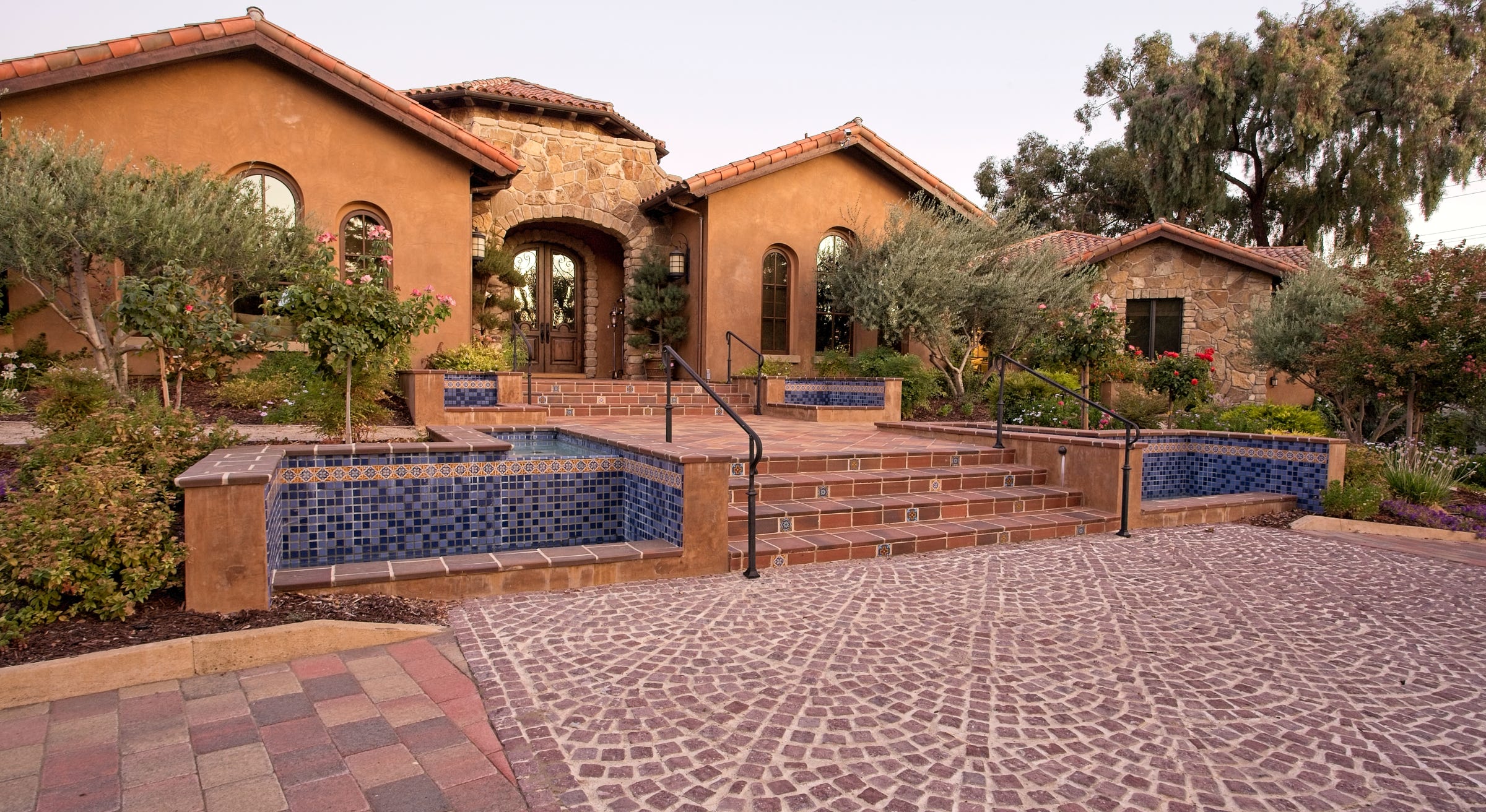 Spanish style landscapes with many custom fountains. Porphyry paving, too.